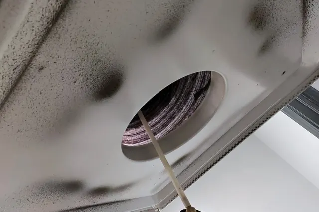 Dust and soot built up on a ceiling supply vent