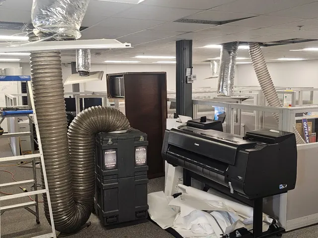 Negative-air duct cleaning in an office building