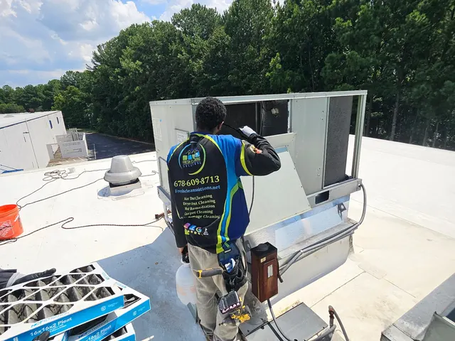 Working on a commercial rooftop unit