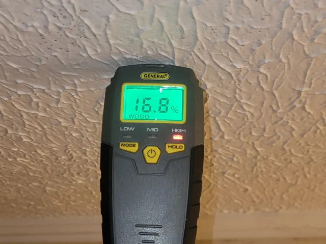 Moisture meter reading on a ceiling during a mold inspection